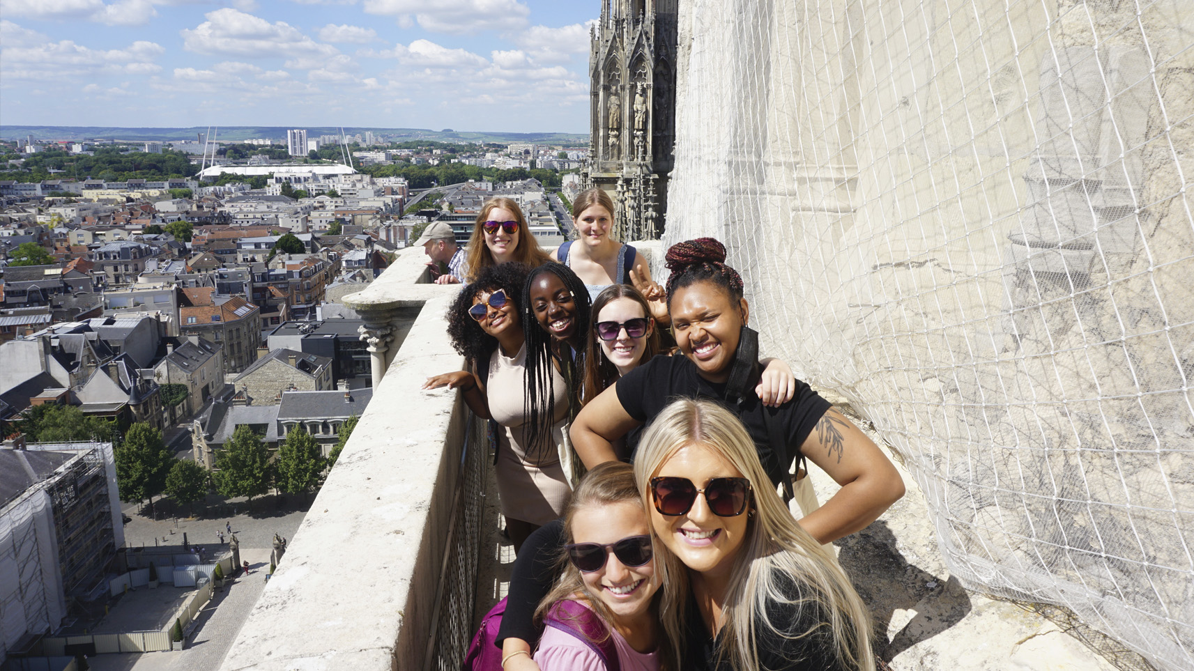 Group of study abroad students leaning on railing