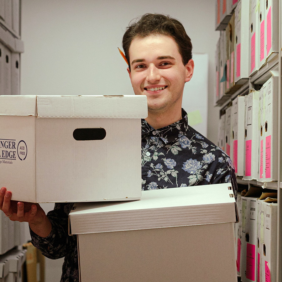 Photo of Layk holding filing boxes