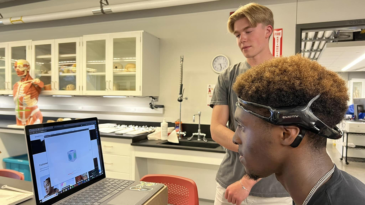 Two students in a lab looking over results on computer screen