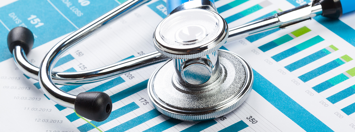 Stethoscope resting on a page layout of graphical data