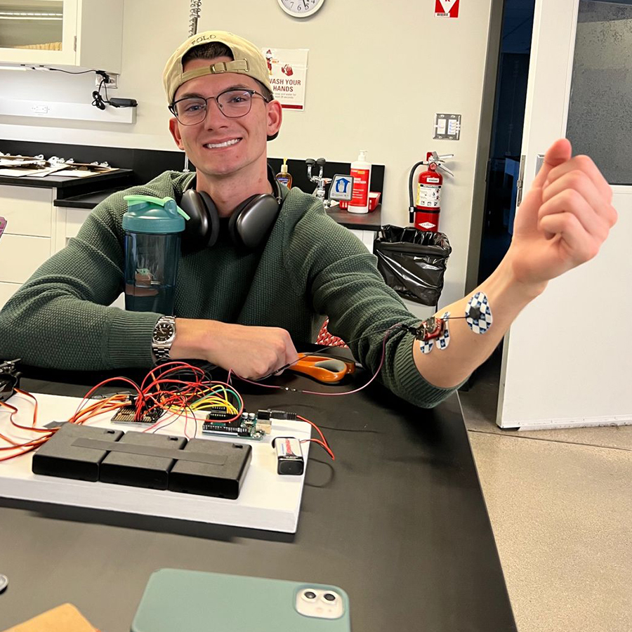 photo of student with arm hooked up to a vitals machine