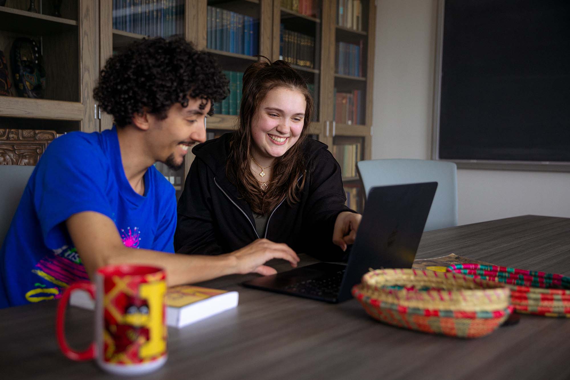 An advisor and a student sit at a table